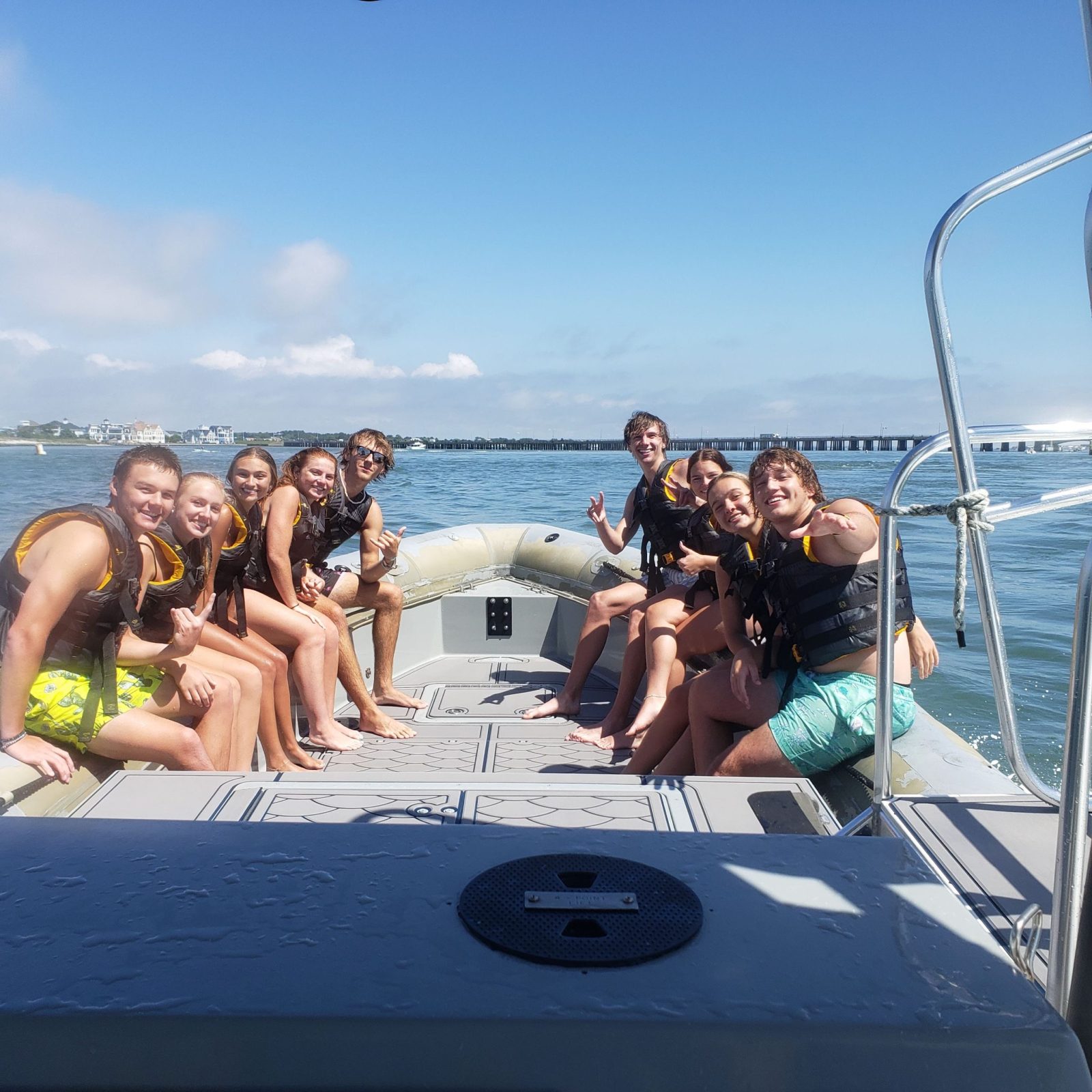 a group of people standing next to a body of water